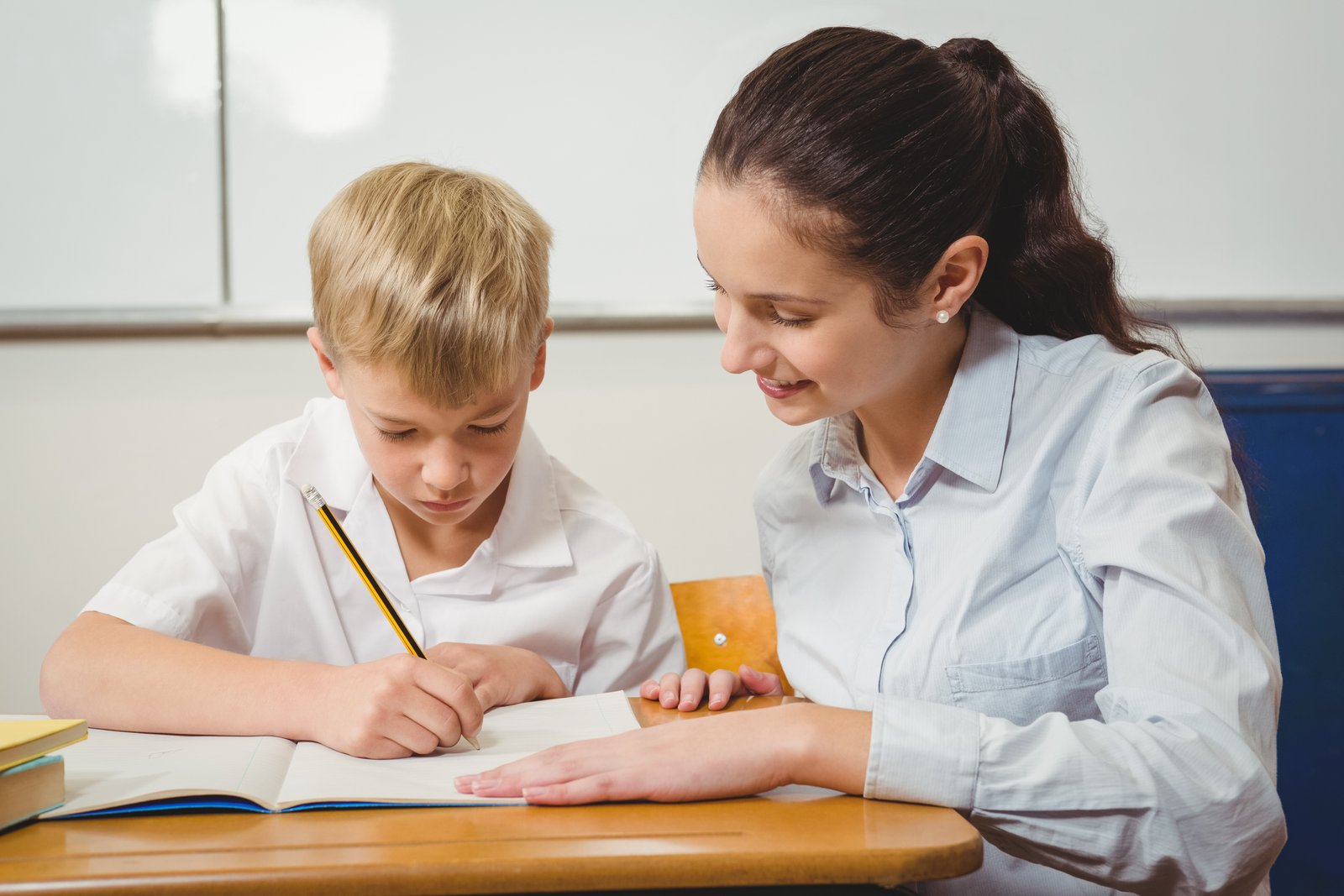 Tutor helping a student with 11 Plus entrance exam preparation work