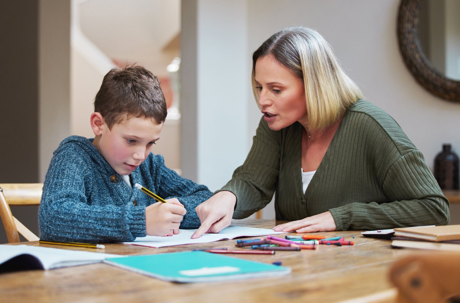 Parent supporting a child with homework during private one-to-one tuition